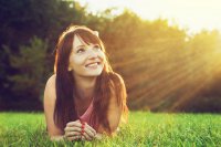 Woman in a field looking to the sky