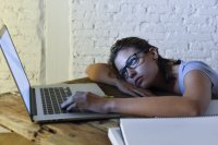 Exhausted student at laptop