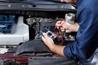 Automotive technician diagnosing engine trouble