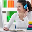 Student at desk with headphones on