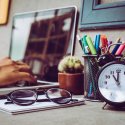 Desk with laptop and clock