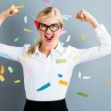 Strong professional woman with confetti floating around her