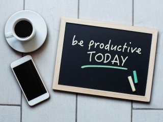 A chalkboard with "be productive today" written in chalk